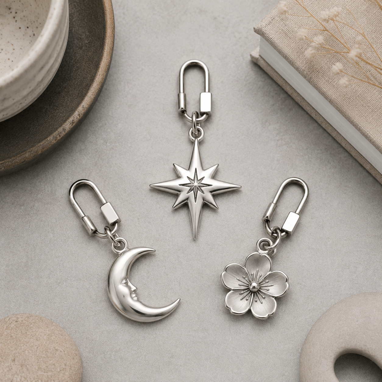 Close-up of a 316L stainless steel bag charm with a PVD gold finish on a clean, neutral background