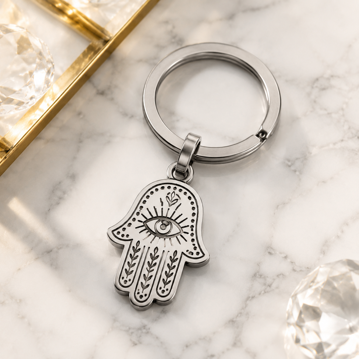 Close-up of 316L stainless steel charm with PVD gold plating on white background