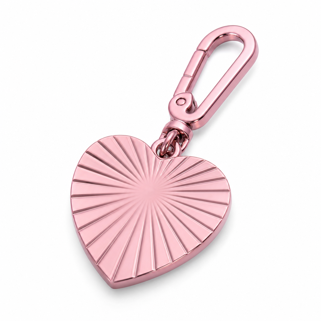 Close-up of a pink PVD finish on a 316L stainless steel charm in a controlled studio setting
