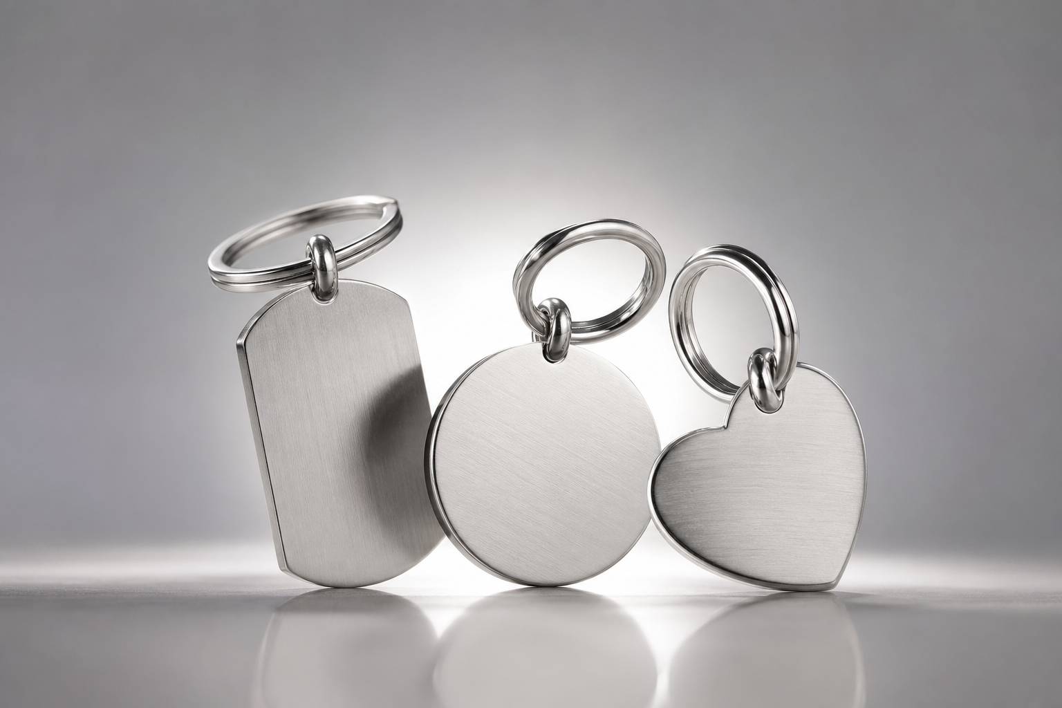 316L stainless steel blank keychain charm on a clean white background showing a visible bail and through-hole