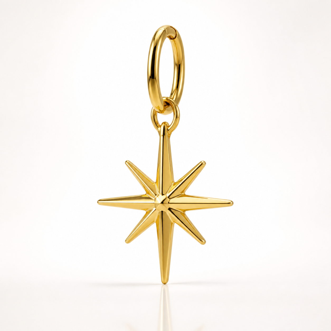 close-up of a 316L stainless steel gold-plated keychain charm with visible bail and polished finish on white background