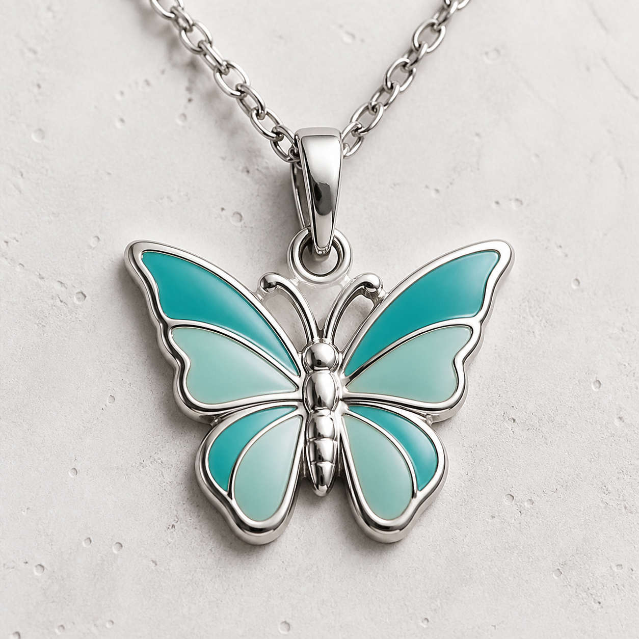 Premium studio shot of a 316L stainless steel enamel butterfly charm on white background