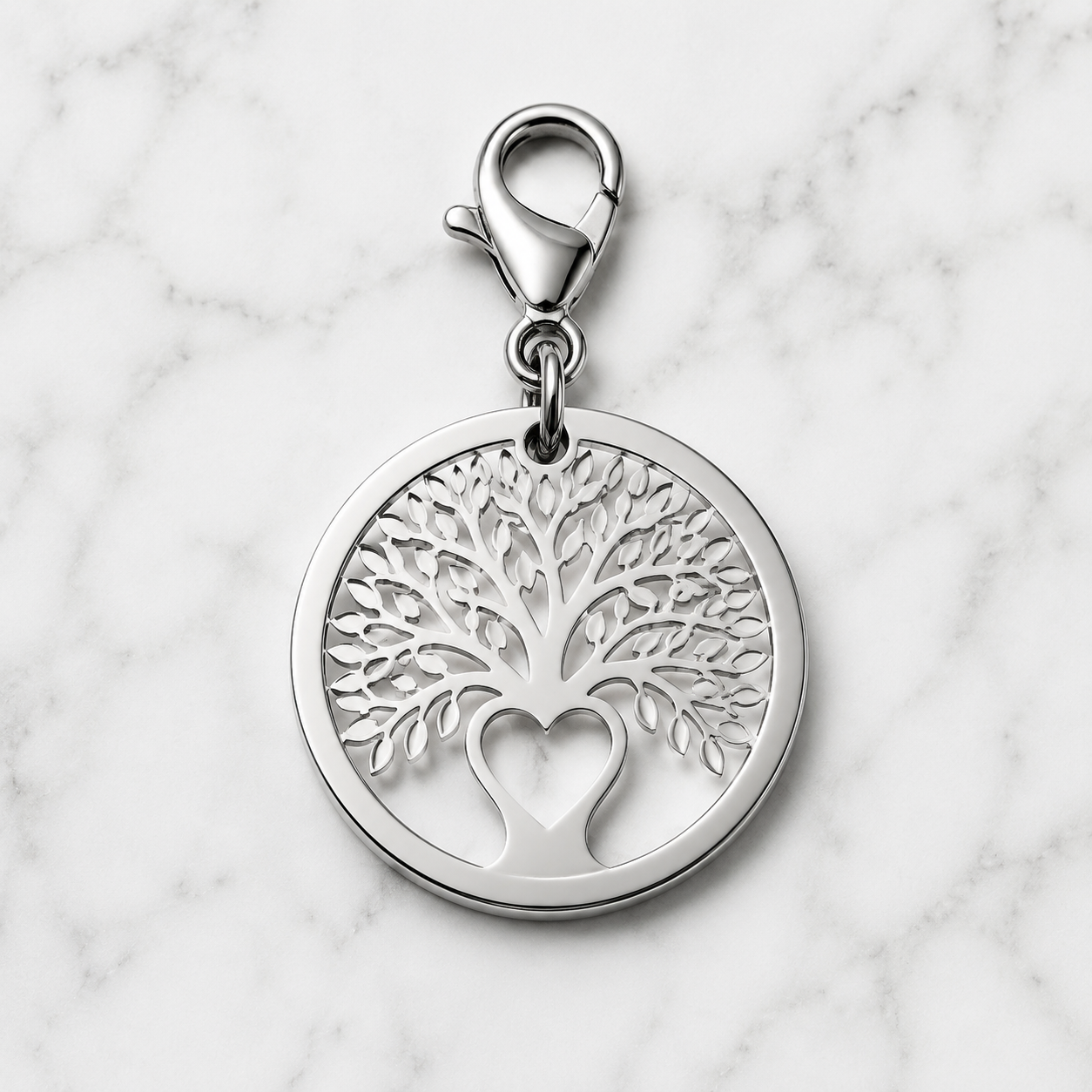 studio product photography of a 316L stainless steel memorial car charm with visible jump ring and premium packaging card