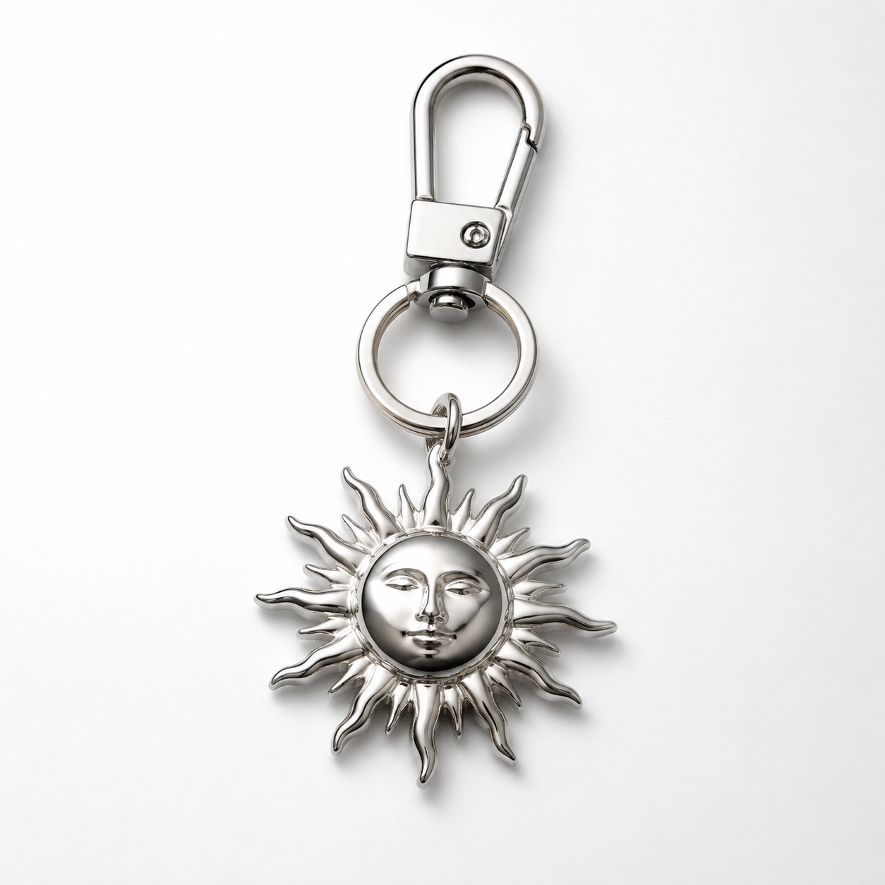 studio product photography of 316L stainless steel charm keychains with visible PVD finishes on a clean white background