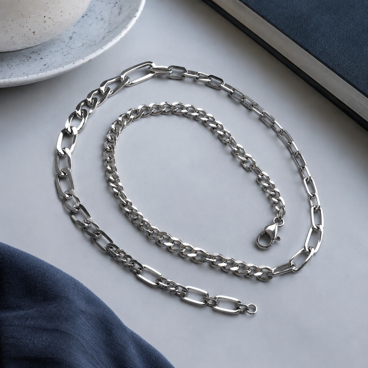 Studio product photography of a single 316L stainless steel charm with visible jump ring and polished finish on a white background
