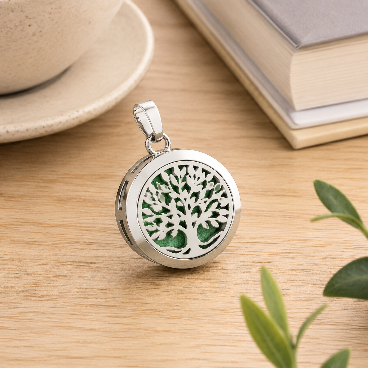 Premium studio product photography of customized 316L stainless steel aromatherapy charm samples on a neutral display tray